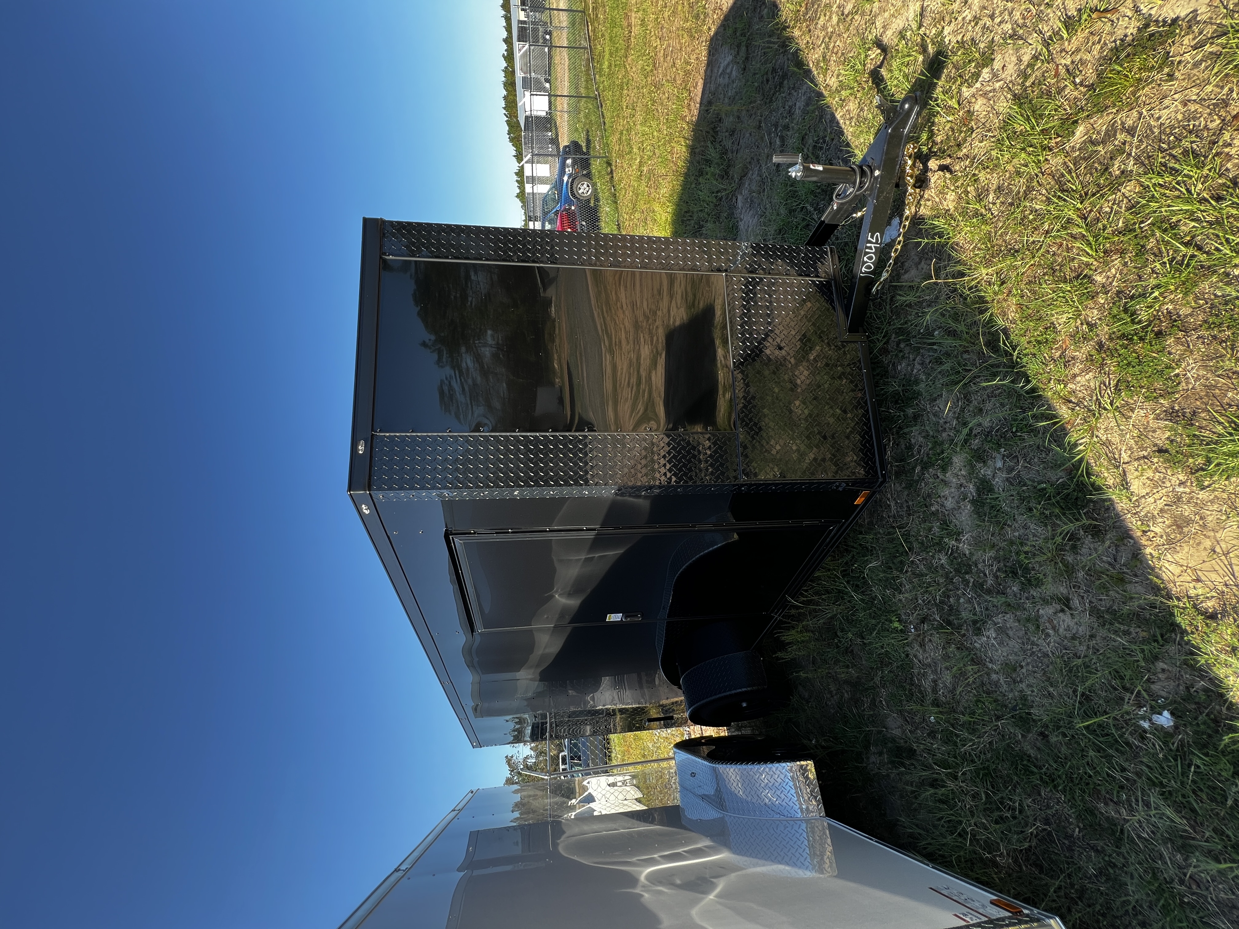 Black enclosed 6x12 single axle cargo trailer with blackout trim and 3500lb leaf spring axle