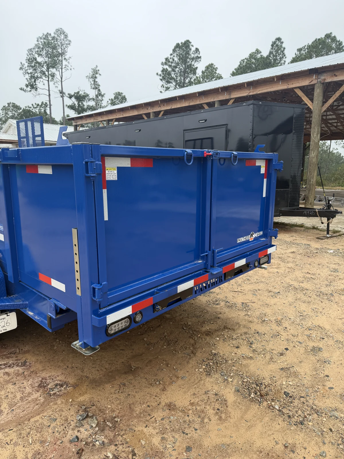 Royal Blue dump trailer rear barn doors with reflective strips and rear lights