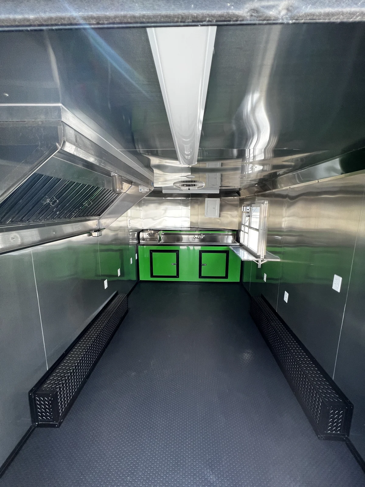 8.5x16 concession interior with mill-finish walls and ceiling, RTP flooring, hood vent, and green base cabinets